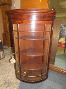 A 19TH CENTURY GLAZED BOW FRONTED HANGING CORNER CABINET