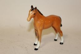 A BESWICK CHESTNUT FOAL