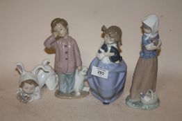 FOUR NAO FIGURES TO INCLUDE A BOY WITH A TEDDY BEAR, CHILD HOLDING A BIRD ETC.