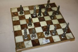 A MARBLE EFFECT CHESS SET WITH METAL CHESS MEN