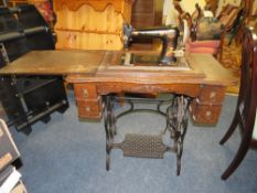 A VINTAGE OAK TREADLE SEWING MACHINE WITH 'THE AVENUE' AMERICAN MADE MACHINE
