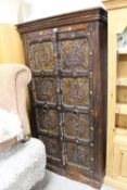 AN UNUSUAL COLONIAL STYLE TWO DOOR CUPBOARD WITH METALLIC EMBOSSED PANELS H-181 W-95 CM