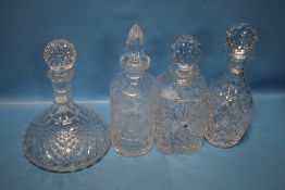 FOUR ASSORTED CUT GLASS DECANTERS