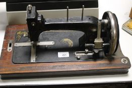 A VINTAGE CASED SEWING MACHINE