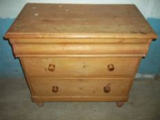 A SOLID PINE THREE DRAWER CHEST OF DRAWERS