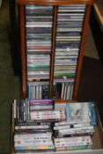 A QUANTITY OF CDS AND DVDS (BOX AND CD RACK)