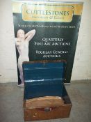 A SMALL METAL TRAVEL TRUNK