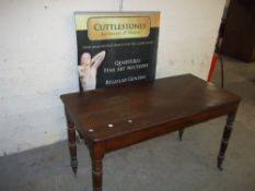 AN ANTIQUE MAHOGANY HALF WIND OUT TABLE (WORMED)