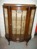 A BOWED CHINA CABINET