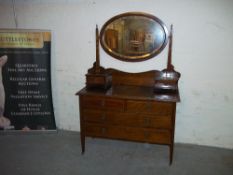AN EDWARDIAN DRESSING TABLE WITH OVAL MIRROR