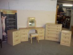 A MODERN BEDROOM SET TO INCLUDE FIVE DRAWER CHEST, DRESSING TABLE AND TWO THREE DRAWER CHESTS