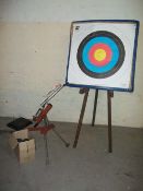 AN ARCHERY TARGET BOARD AND STAND TOGETHER WITH CLAY PIGEON LAUNCHER AND CLAY PIGEONS