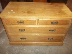 AN OAK CHEST OF DRAWERS (TWO OVER TWO) WITH BRASS DROP SWAN NECK HANDLES