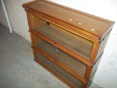 A WERNICKE STYLE SECTIONAL BOOKCASE BY A. M. Y. L. (WITH CRACKED GLASS)