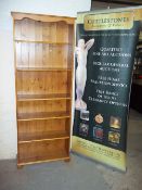 A NARROW PINE BOOKSHELF