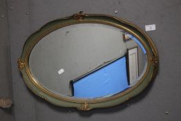 A BEVEL EDGED GILT FRAMED OVAL MIRROR 62 X 40 CM