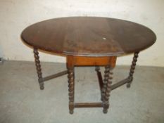 AN OAK DROP LEAF TABLE WITH BARLEY TWIST LEGS