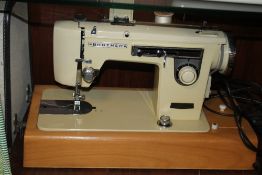 A CASED BROTHER SEWING MACHINE AND A COLLECTION OF ASSORTED SEWING ACCESSORIES