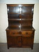 AN OAK LINENFOLD DRESSER WITH WALL UNIT (SMALL AMOUNT OF WORM)