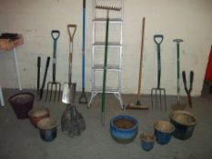 A SELECTION OF GARDEN TOOLS AND GLAZED PLANTERS WITH A CONCRETE SWAN PLANTER