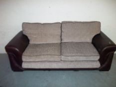 A THREE SEATER FABRIC / FAUX LEATHER SOFA