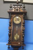 A HANGING WALL CLOCK A/F WITH KEY AND PENDULUM