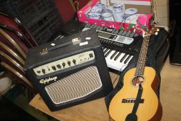 AN EPIPHONE AMPLIFIER, AN ELECTRIC KEYBOARD (NO PLUG) AND A SMALL ACOUSTIC GUITAR