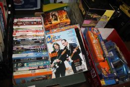 A TRAY OF DVDS TOGETHER WITH A BOX OF TOY VEHICLES TO INCLUDE A REMOTE CONTROL CAR