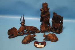 A COLLECTION OF CARVED WOODEN FIGURES