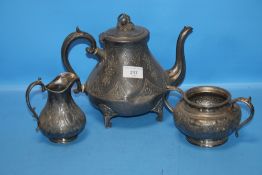 A THREE PIECE WHITE METAL COFFEE SET