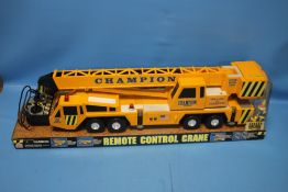 A CHAMPION REMOTE CONTROL CRANE IN ORIGINAL PACKAGING