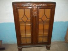 AN OAK ANTIQUE BOOK CASE