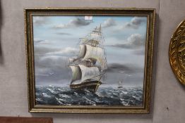 FRAMED AND GLAZED OIL PAINTING OF A GALLEON AT SEA - 60CM X 50CM