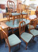 A MODERN EXTENDING DINING TABLE WITH EIGHT CHAIRS