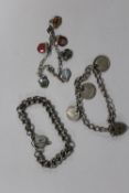 THREE SILVER BRACELETS TO INCLUDE A CHARM BRACELET, COIN BRACELET ETC. APPROX WEIGHT - 48.1G