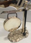 A SILVER PLATED DINNER GONG MODELLED AS A DIRECTIONAL SIGN SAYING 'THIS WAY' WITH YOUNG GIRL