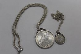 TWO WHITE METAL COINS IN MOUNTS ON SILVER CHAINS APPROX WEIGHT - 65.8G