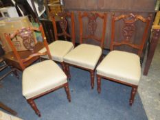 A SET OF FOUR EDWARDIAN CARVED MAHOGANY DINING CHAIRS