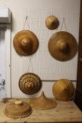 A COLLECTION OF HAND WOVEN VIETNAMESE STYLE TRADITIONAL HATS