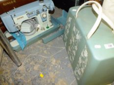 A CASED JONES ELECTRIC SEWING MACHINE