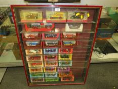 A GLASS WALL HANGING DISPLAY CASE, CONTAINING BOXED DIE CAST CARS, CABINET H 87 CM, W 68 CM