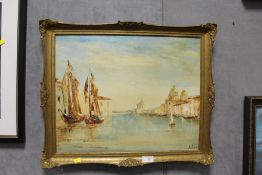 GILT FRAMED OIL ON BOARD CONTINENTAL RIVER SCENE WITH MOORED BOATS SIGNED JEAN CALEY LOWER RIGHT -