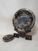 A CHINESE / ORIENTAL SHALLOW BOWL DECORATED WITH DRAGONS AND FIGURES, WITH ORANGE BACKSTAMP, ON HARD