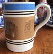 GEORGIAN MOCHA WARE TANKARD WITH BLUE RIM AND TREE DESIGN, PRINTED MARK TO FRONT, DATING TO PRE