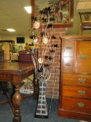 A MODERN METAL FLOWER DISPLAY IN VASE H 155 CM TOGETHER WITH A PAINTED STANDARD LAMP (2)
