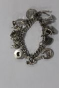 A LARGE HALLMARKED SILVER CHARM BRACELET APPROX WEIGHT 59.7G
