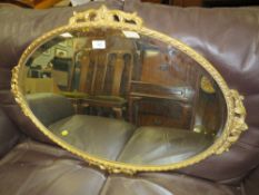 A GILT OVAL WALL MIRROR W-86 CM