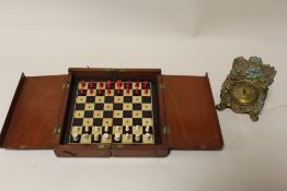 A VINTAGE MAHOGANY TRAVELLING CHESS SET TOGETHER WITH A VINTAGE GILT CLOCK