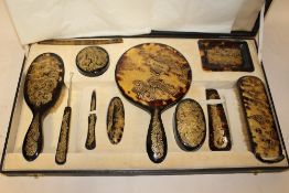 AN ORIENTAL STYLE CASED TORTOISE SHELL DRESSING TABLE SET