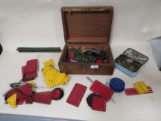 A MAHOGANY BOX OF MECCANO TOYS